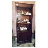 Dark wood bookcase with upper shelves and lower..