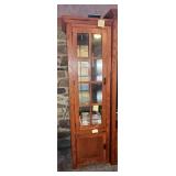 Brown oak corner curio cabinet with a glass-pan..
