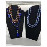 A Collection of Blue Orange and Clear Beaded Neckl