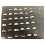 Assorted unbranded menï¿½s rings appear titanium
