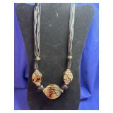 statement necklace featuring large, patterned