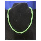green beaded necklace featuring small round green