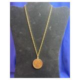 gold-toned coin pendant necklace featuring a