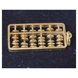 gold-tone miniature abacus pendant featuring