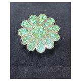 flower-shaped ring featuring green crushed