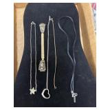 Two necklaces one eyeglass holder, one bracelet