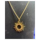 gold-toned sunburst pendant necklace featuring a