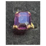gold ring featuring a large, rectangular-cut