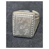 silver signet ring with an engraved monogram on