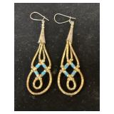 pair of handcrafted dangle earrings featuring