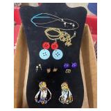 A lot of earrings and two eyeglass holders