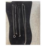 Four Silvertone necklaces
