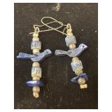 handmade dangling earrings featuring blue bird