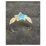 blue star-shaped inlay, likely made of turquoise.