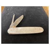 two-blade folding pocket knife with a worn metal