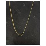 Gold tone necklace with a tiny diamond pendant