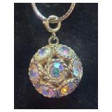 gold-tone 3D orb pendant that appears to be