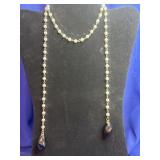 delicate beaded necklace with two dark, tumbled