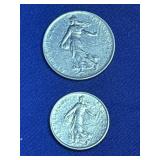 Two  French Franc coins featuring the iconic