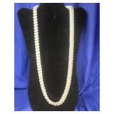 white beaded necklace with smooth, oval-shaped