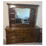 wooden dresser with an attached mirror