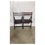 Wooden folding chairs with black vinyl padded