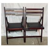 Wooden folding chairs with black vinyl padded