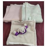 Vintage baby blankets and a small teddy bear