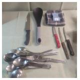 Silverware, knives and a dish cloth Silverware, knives and a dish cloth