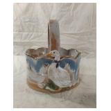 Vintage ceramic duck basket features a blue drip