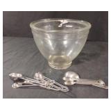Glass bowl and metal measuring spoons