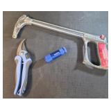 hacksaw frame, pruning shears, and a small