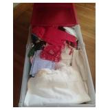 Vintage quilt pieces in tub with lid