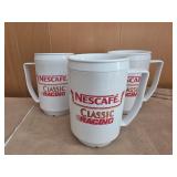 3 white plastic mugs are Nescafï¿½ promotional