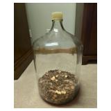 large glass carboy partially filled with U.S.