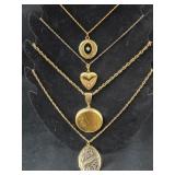 4 gold colored necklaces with lockets