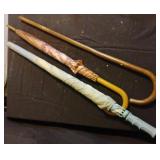 2 umbrellas and a walking cane