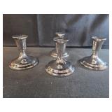Four weighted sterling silver candlestick holders