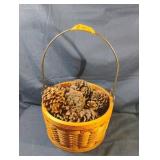 Woven handled basket with pinecones