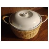 Ceramic casserole dish in a handled basket
