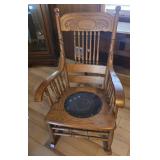 antique oak press-back rocking chair with a