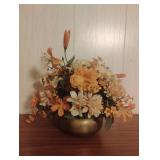 Brass vase with floral arrangement