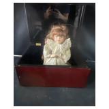 Praying porcelain doll with a box
