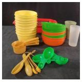 Plastic bowls, measuring spoons, cups and a