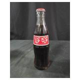 vintage glass Coca-Cola bottle with a red and