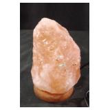 Himalayan pink salt lamp mounted on a round