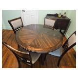 Round Wood Dining Table with Four Upholstered Chai
