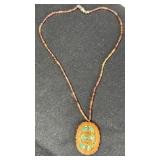 Walnut Shell Pandant w/Inlaid Turquoise on 16'