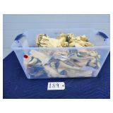 Large bin filled with pairs of cotton work gloves