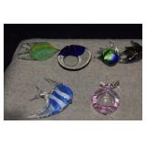 Three Glass Fish That Sit on Glass Wave Base, A